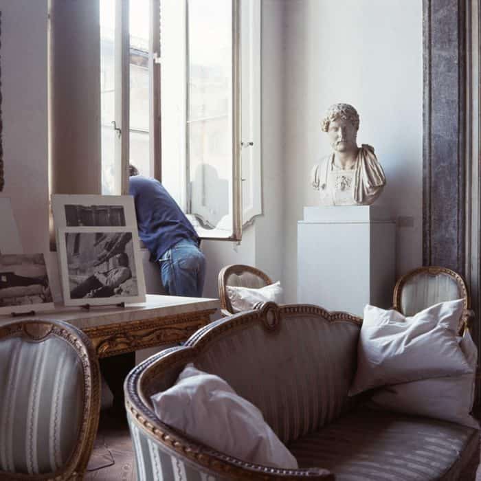 Cy Twombly looking out of the window of his palazzo in Rome, 1966.